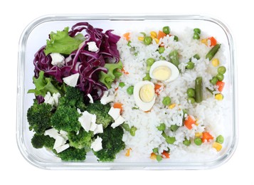 Photo of Tasty rice with boiled egg and vegetables in glass container isolated on white, top view