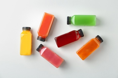 Flat lay composition with tasty juices on light background