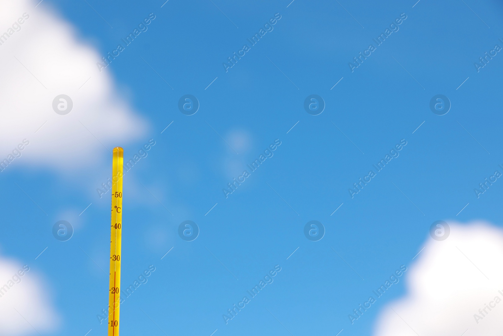 Photo of Weather thermometer against blue sky, space for text