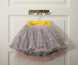 Hangers with beautiful lace skirts on white door