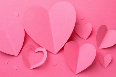 Photo of Paper hearts on pink background, flat lay