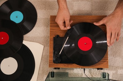 Photo of Man using turntable at home, top view