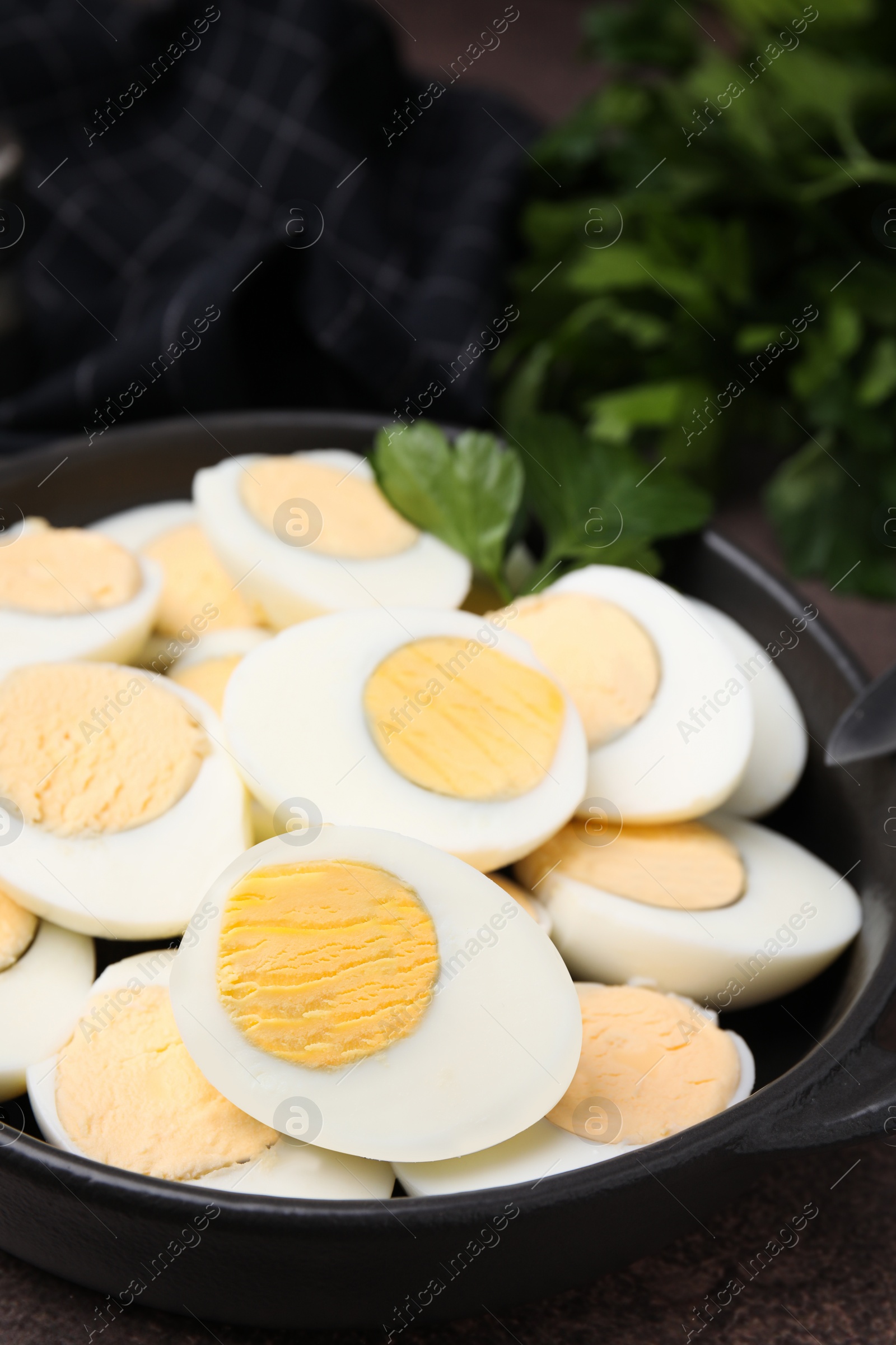 Photo of Fresh hard boiled eggs and parsley on brown table