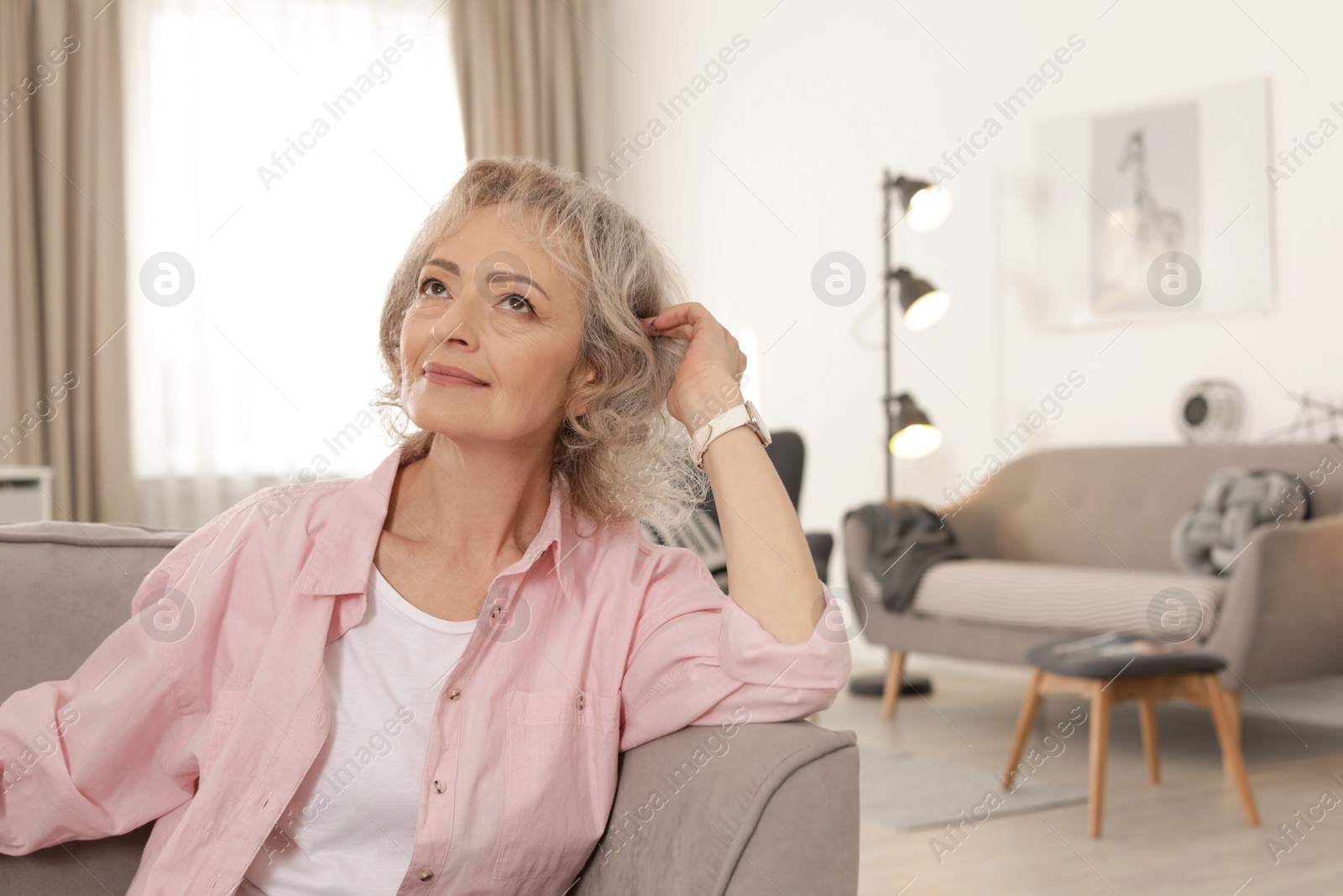 Photo of Portrait of mature woman in living room