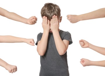 Photo of Kids with clenched fists and upset boy on white background. Children's bullying