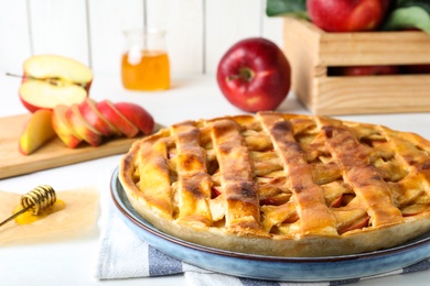 Photo of Fresh traditional apple pie on white table, closeup