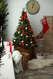 Photo of Stylish room interior with decorated Christmas tree