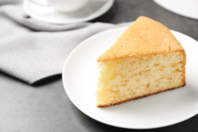 Photo of Piece of delicious fresh homemade cake on grey table
