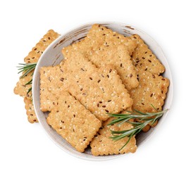 Cereal crackers with flax, sesame seeds and rosemary in bowl isolated on white, top view