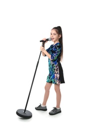 Little girl singing into microphone on white background