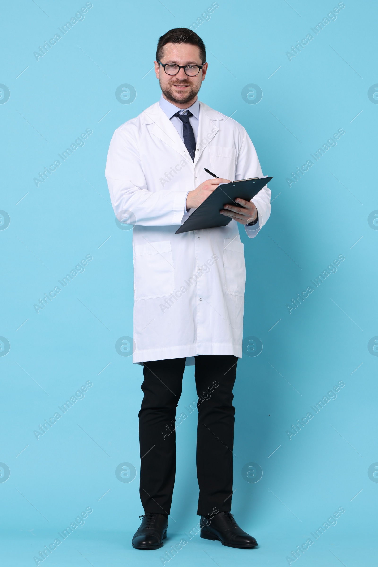 Photo of Doctor with pen and clipboard on light blue background