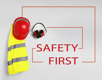 Image of Different safety equipment on light background, flat lay