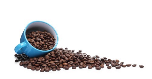 Photo of Overturned cup with roasted coffee beans on white background