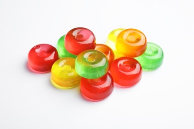 Pile of delicious colorful candies on white background