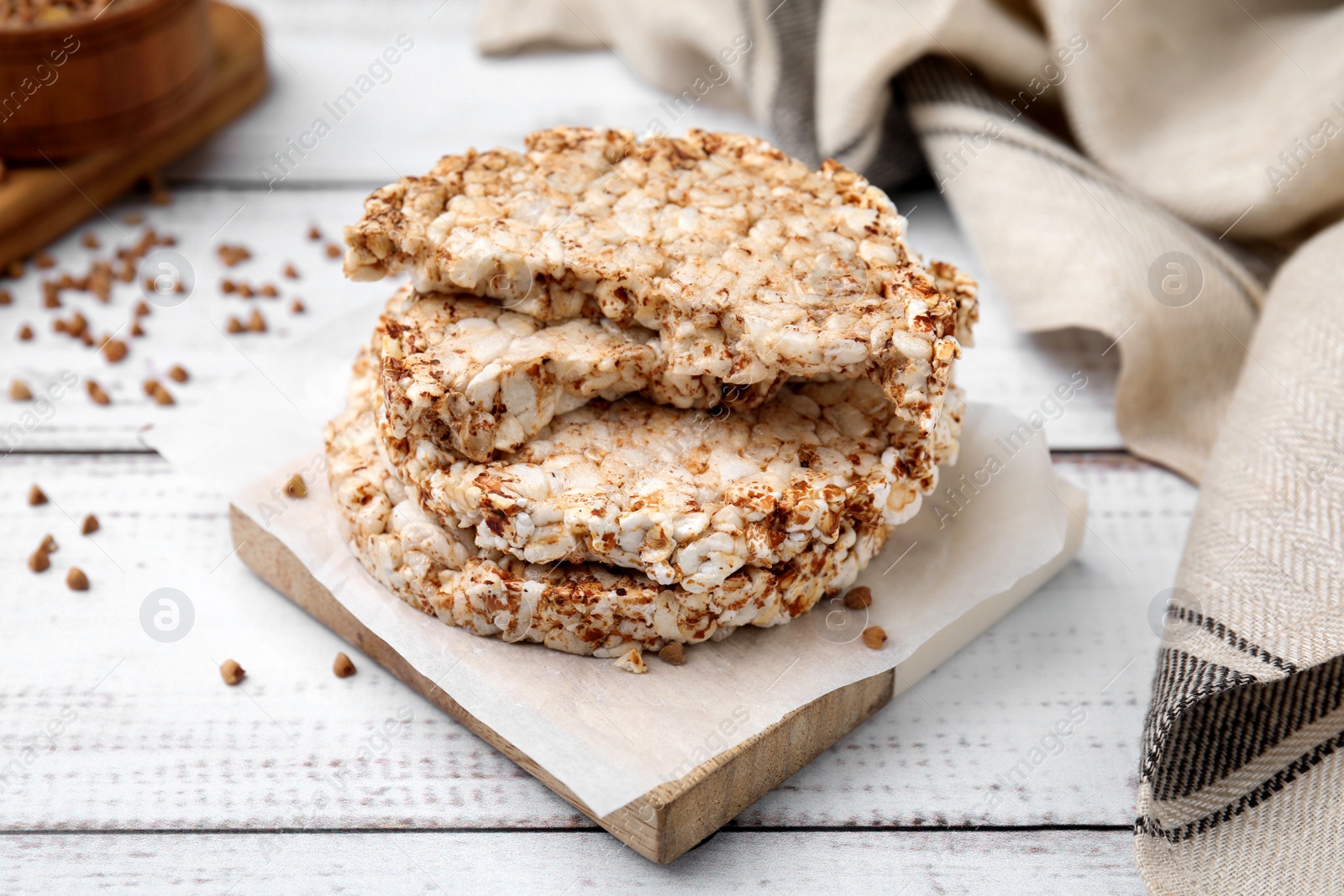 Photo of Stack of crunchy buckwheat cakes on white wooden table