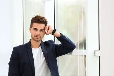 Photo of Portrait of handsome young man near window