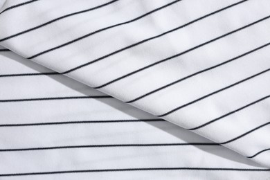 Striped baseball uniform as background, top view