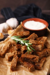 Photo of Crispy rusks with rosemary and sauce, closeup