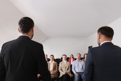 Photo of Business trainers giving lecture in conference room