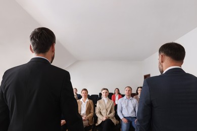 Business trainers giving lecture in conference room