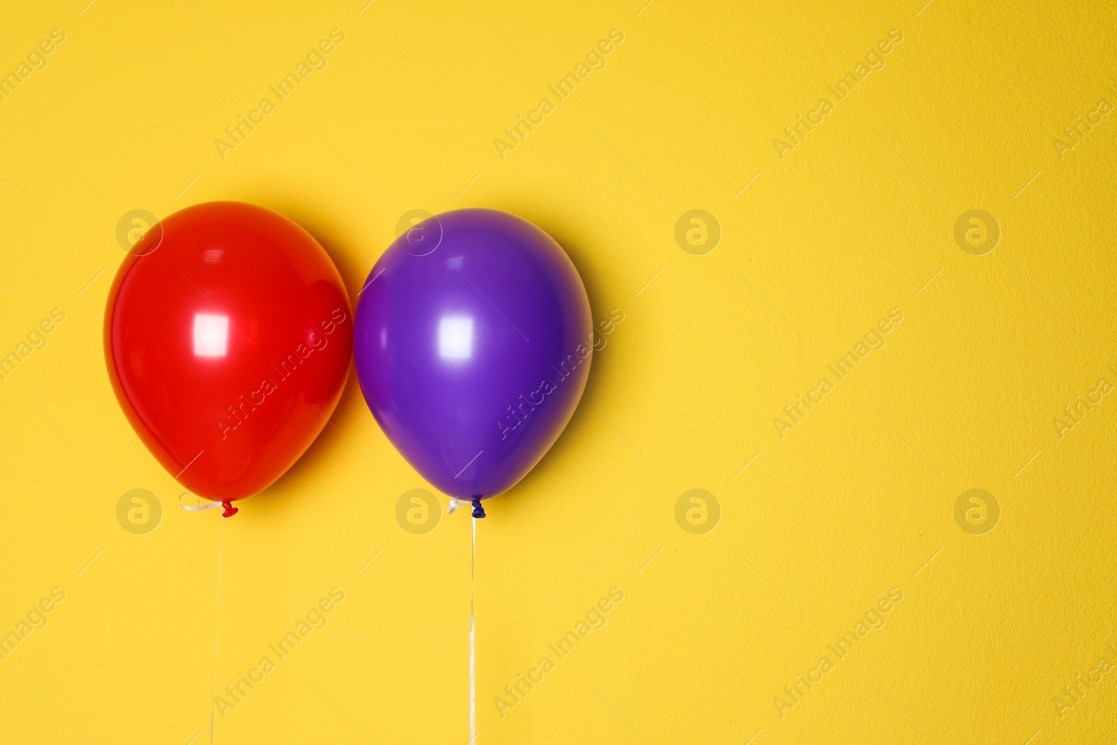 Photo of Different balloons on color background. Celebration time