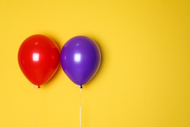 Photo of Different balloons on color background. Celebration time