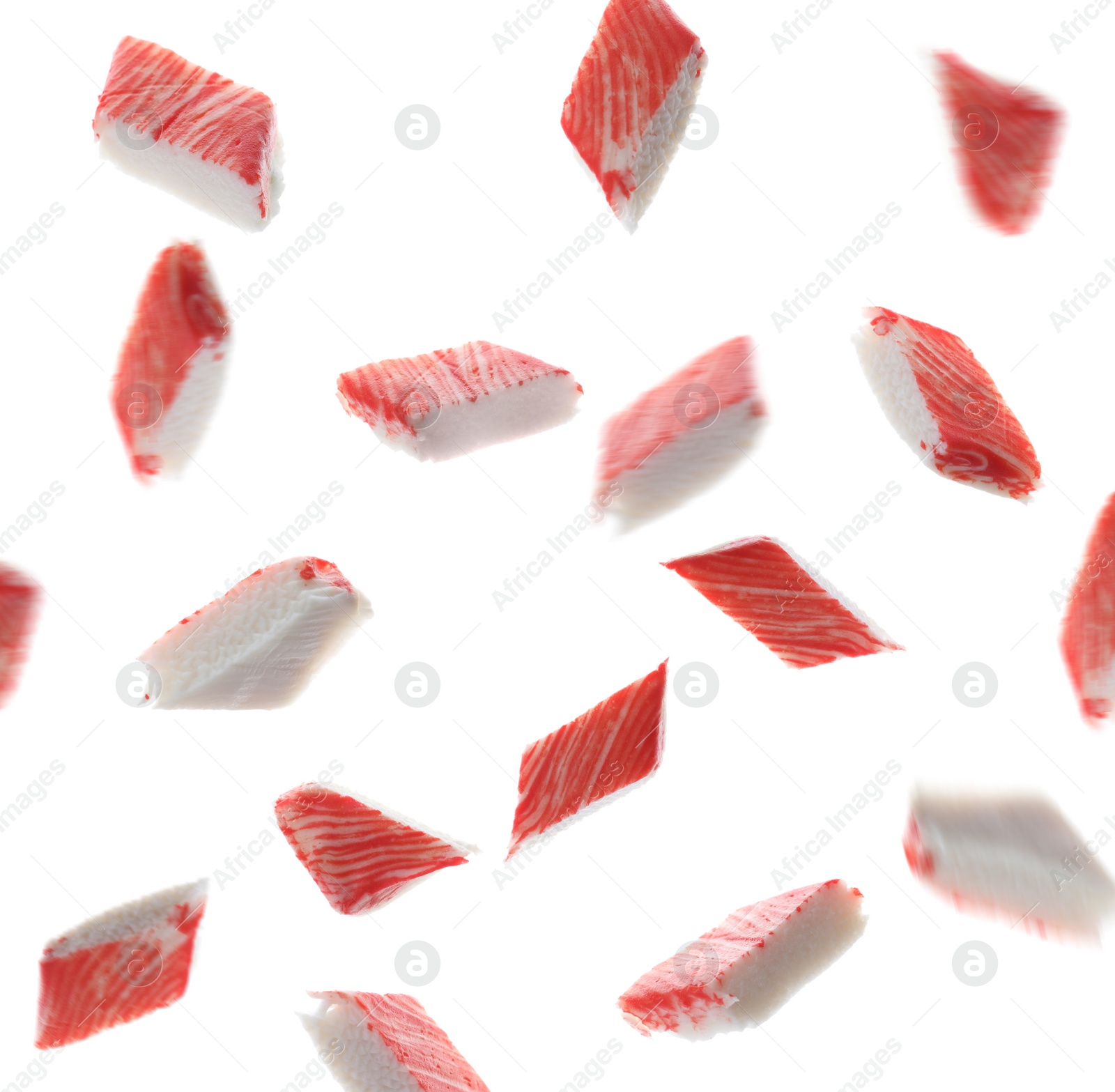 Image of Cut fresh crab sticks falling on white background