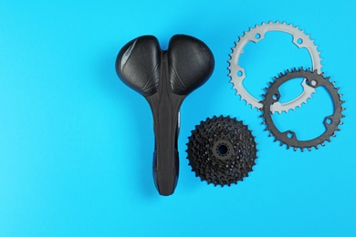 Photo of Set of different bicycle parts on color background, flat lay. Space for text