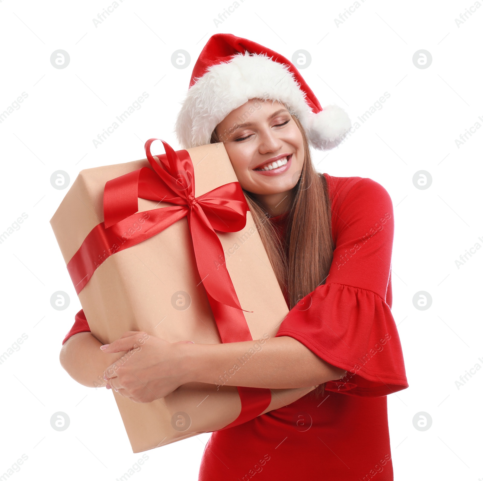 Photo of Happy young woman in Santa hat with Christmas gift on white background