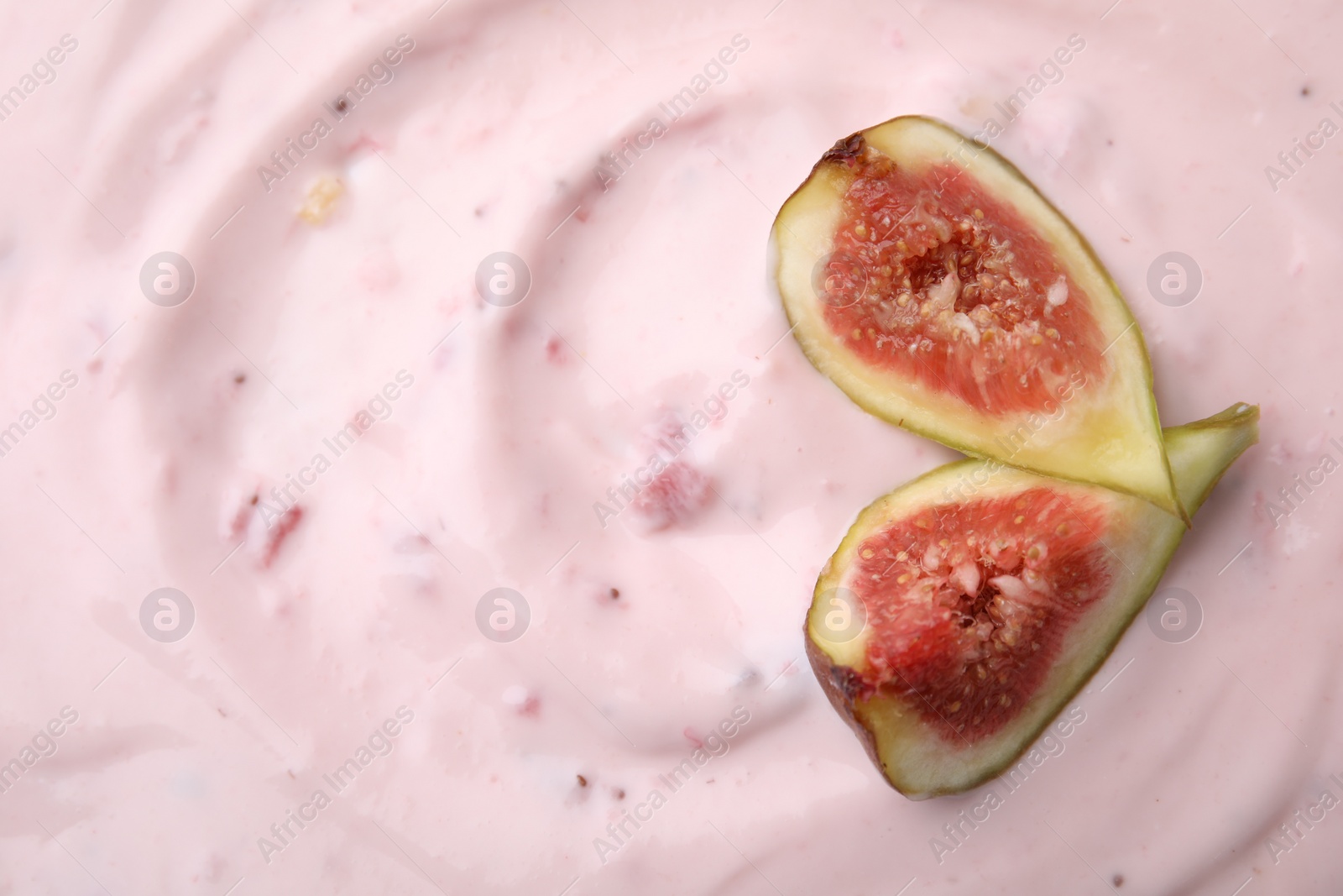 Photo of Tasty yogurt and figs as background, top view. Space for text