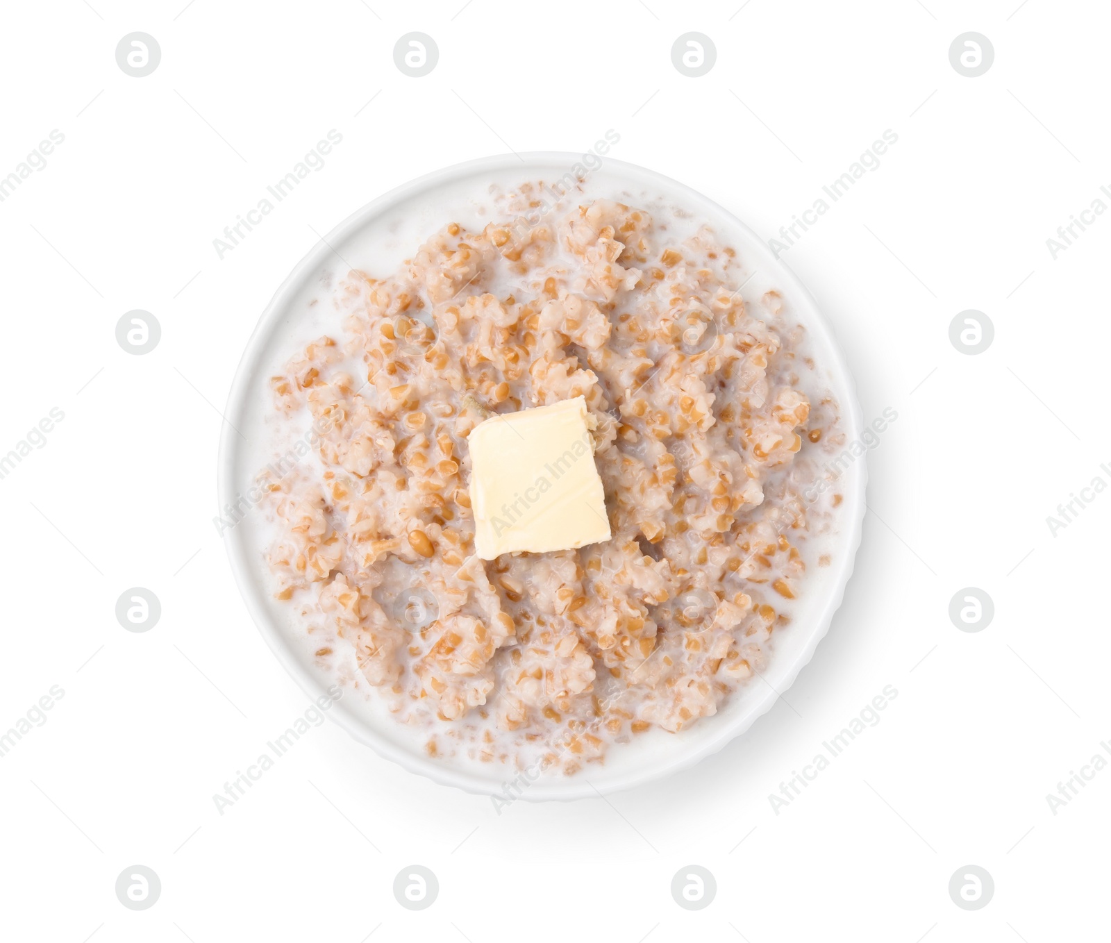 Photo of Tasty wheat porridge with milk and butter in bowl isolated on white, top view