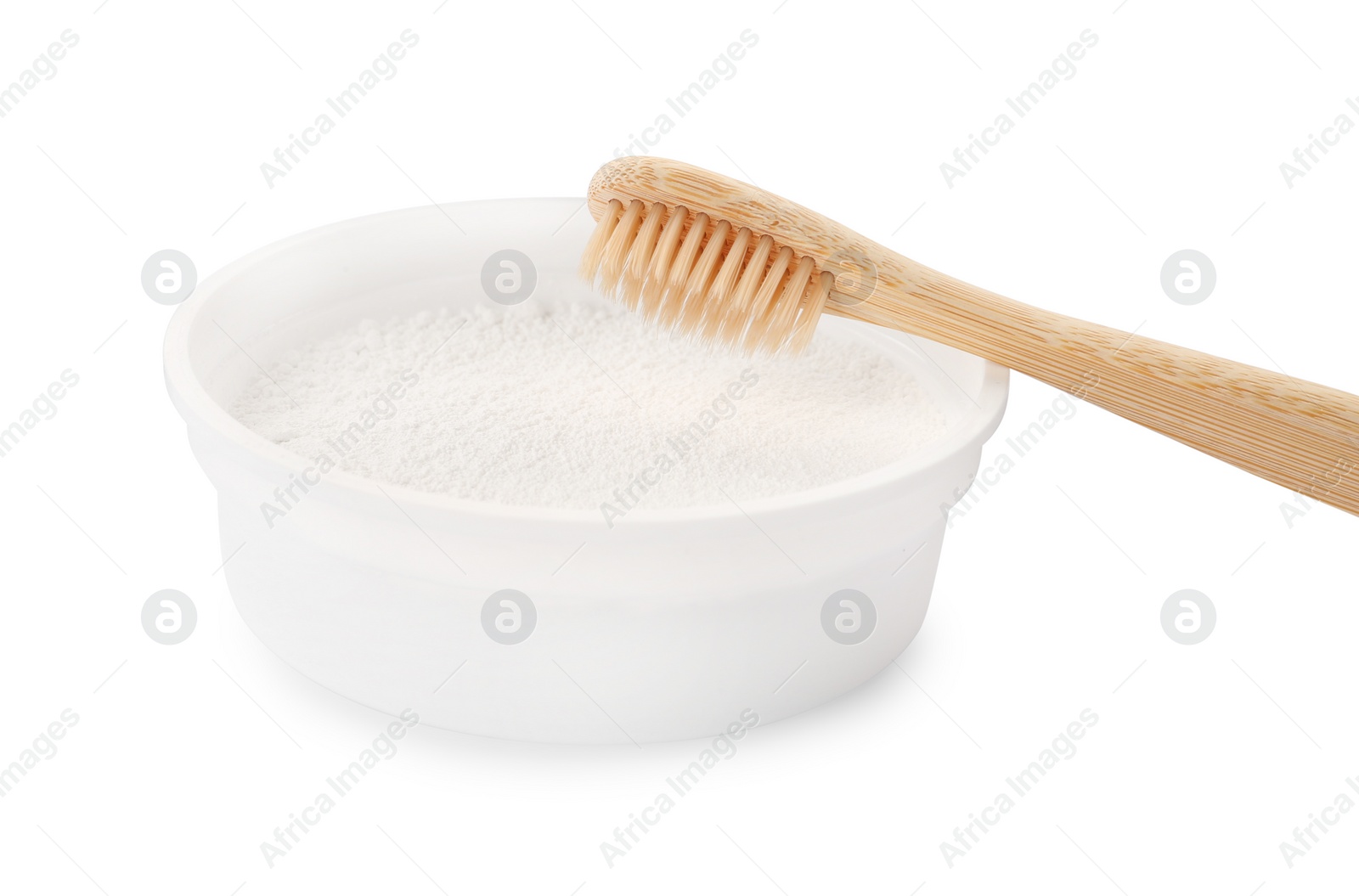 Photo of Bowl of tooth powder and brush on white background