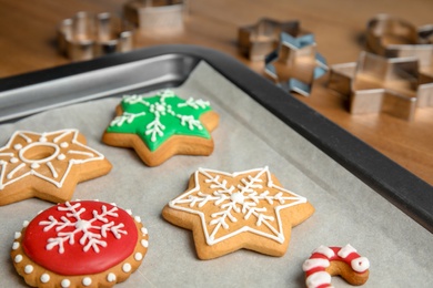 Tasty colorful Christmas cookies on baking tray