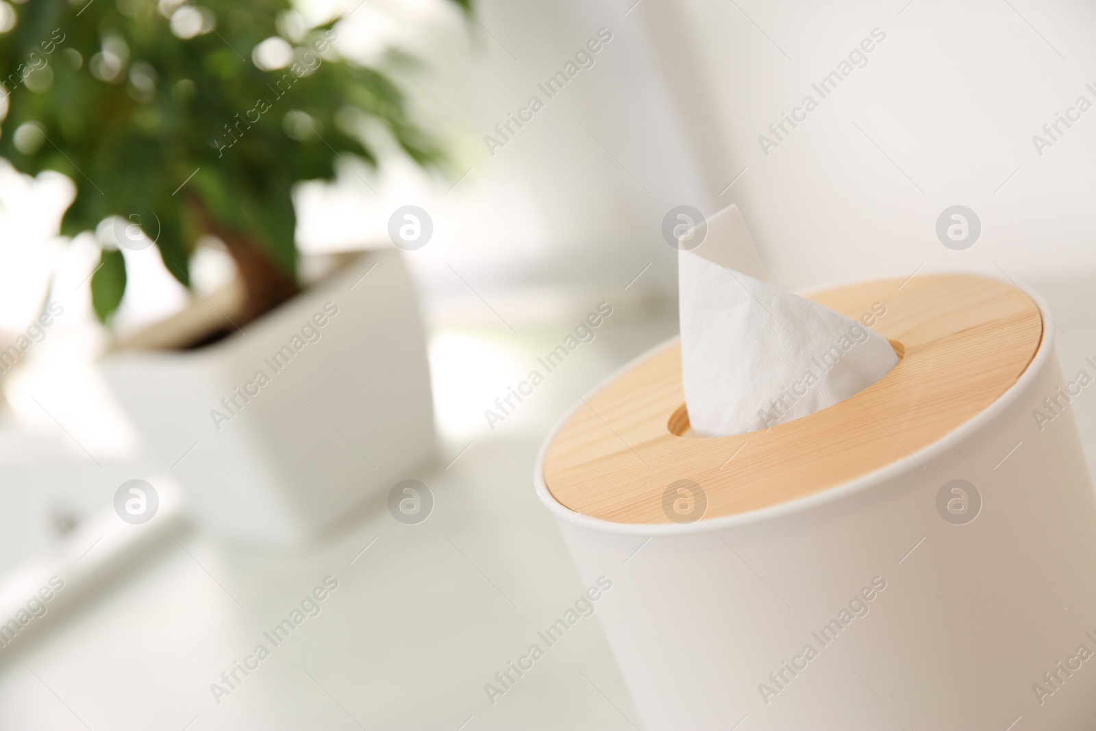 Photo of Box with paper tissues on table, closeup. Space for text