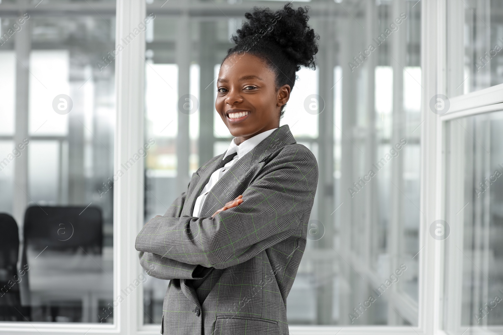 Photo of Happy woman with crossed arms in office. Lawyer, businesswoman, accountant or manager