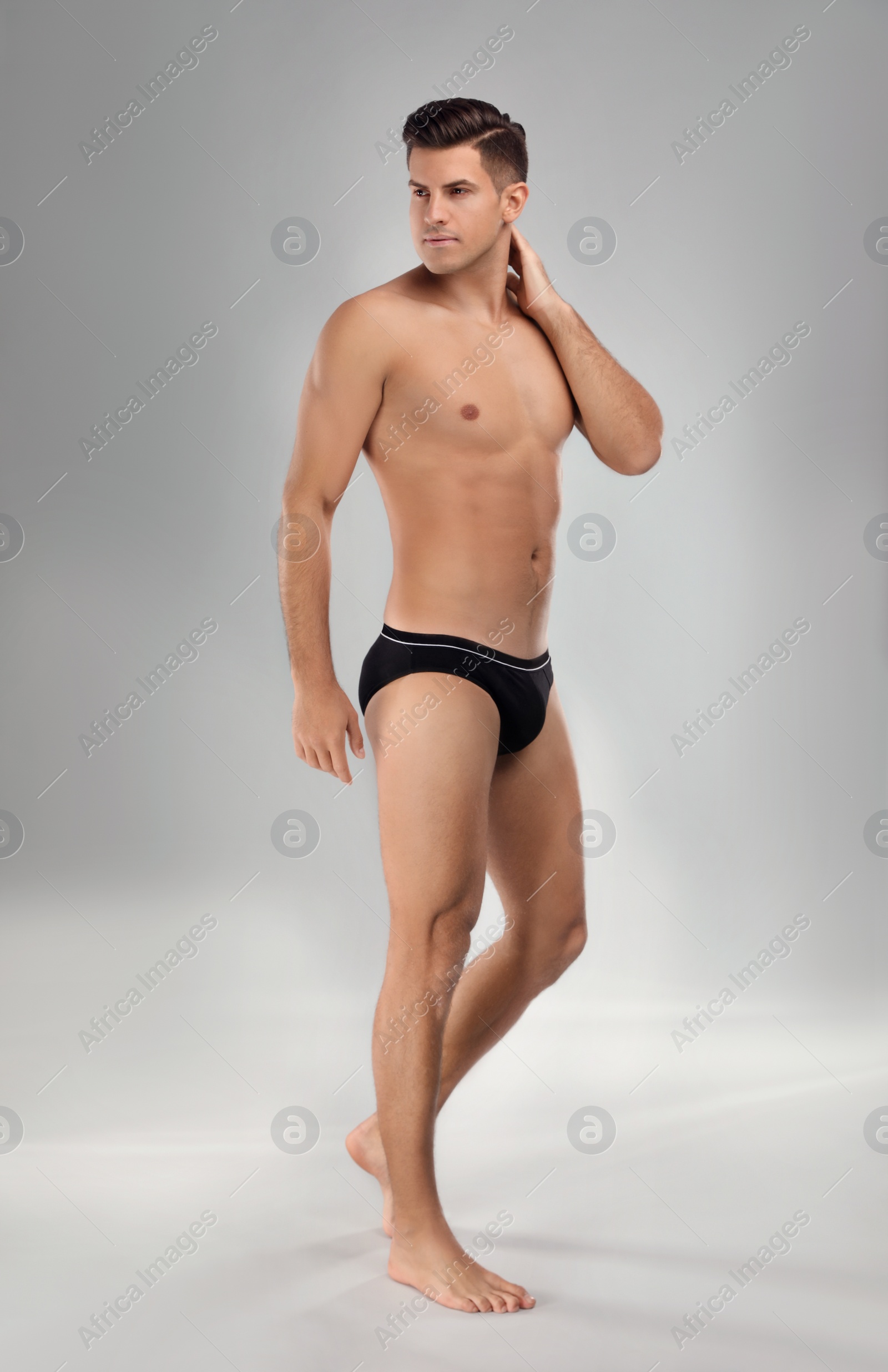 Photo of Handsome man in black underwear on light grey background