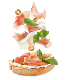 Image of Tasty bruschetta with flying ingredients on white background