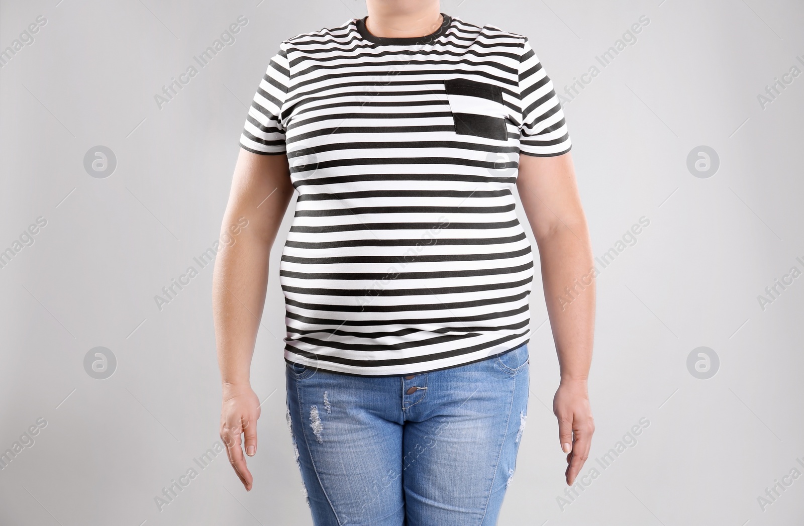 Photo of Fat woman on grey background, closeup. Weight loss