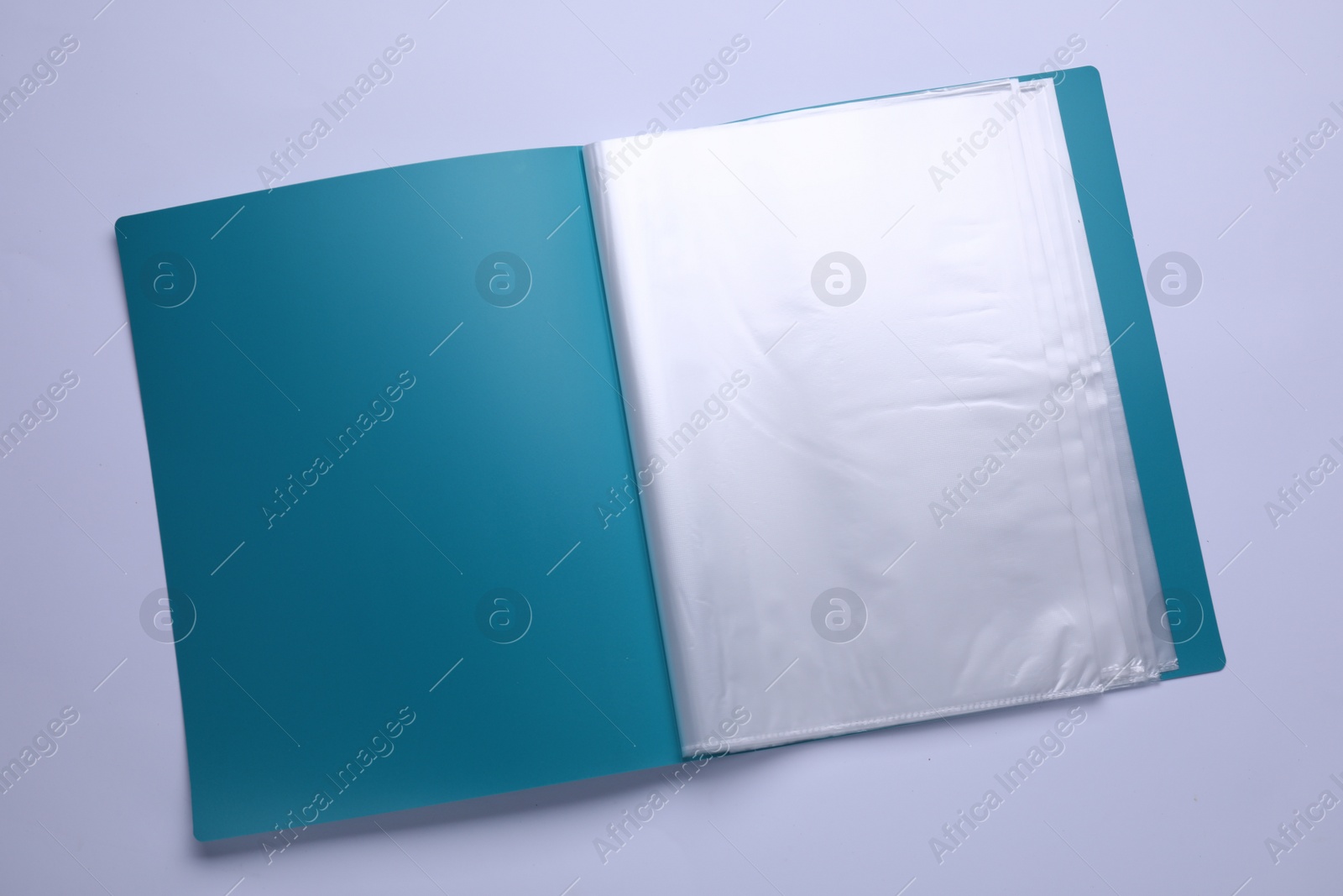 Photo of File folder with punched pockets and paper sheets isolated on white, top view