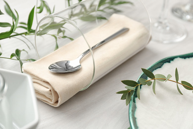 Stylish tableware with leaves on table. Festive setting