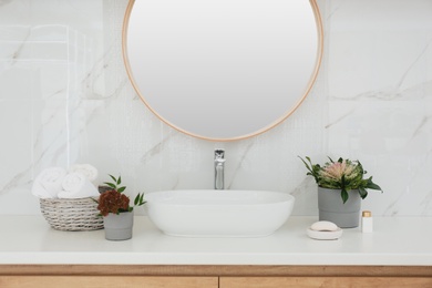 Modern bathroom interior with stylish mirror and vessel sink