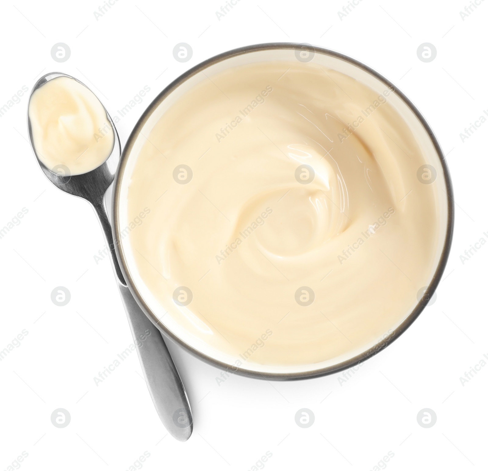 Photo of Ceramic bowl and spoon with mayonnaise on white background