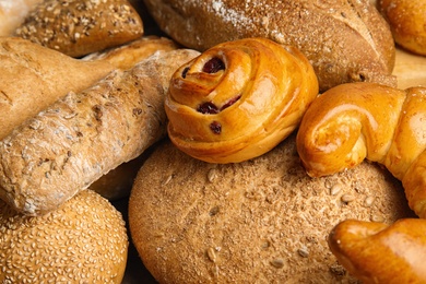 Fresh breads and pastries as background, closeup