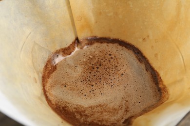 Brewing aromatic drip coffee in paper filter, closeup