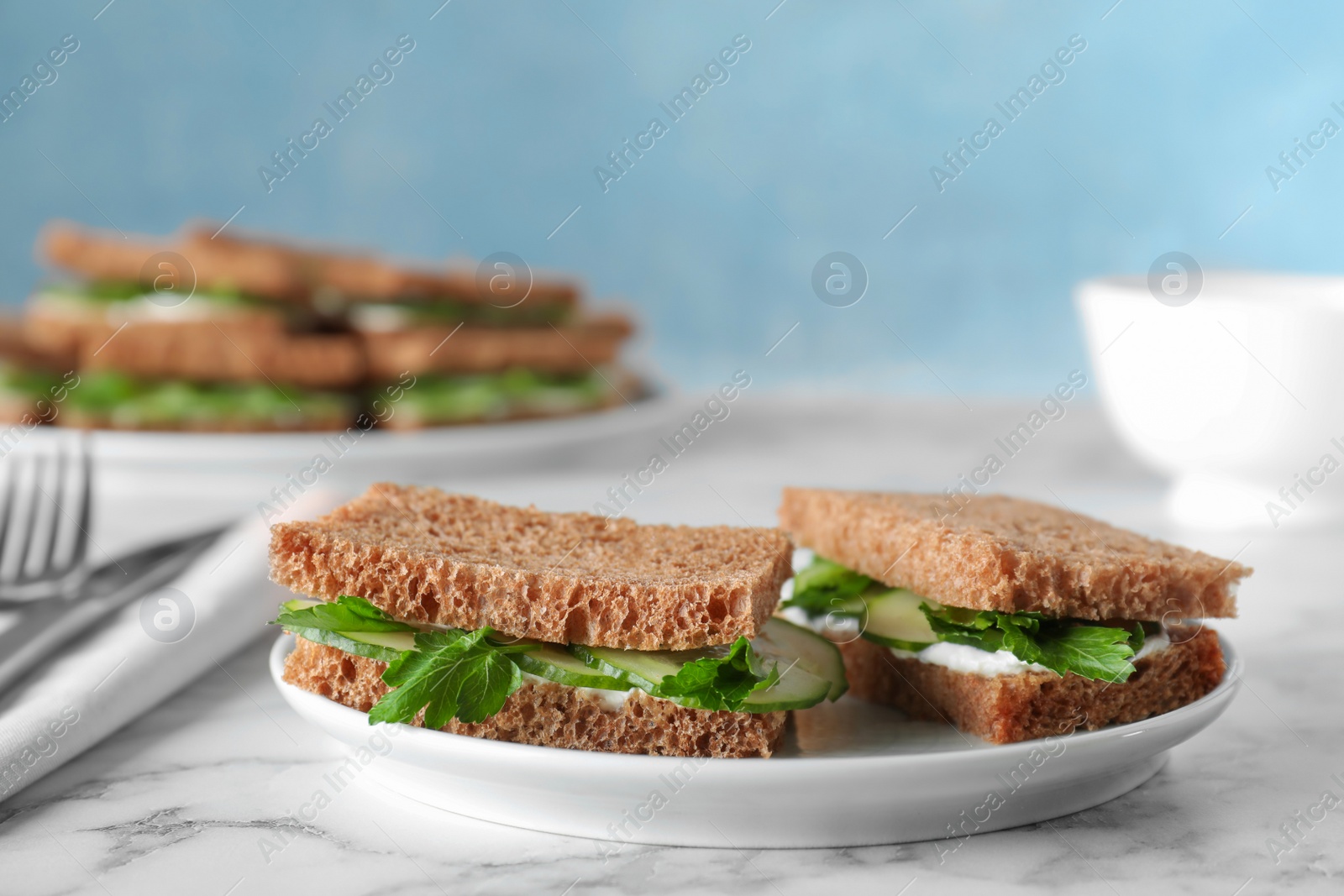 Photo of Plate with traditional English cucumber sandwiches on table. Space for text