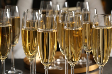 Photo of Glasses of champagne and waiter in restaurant, closeup