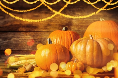 Image of Composition with ripe pumpkins on wooden table, bokeh effect. Happy Thanksgiving day