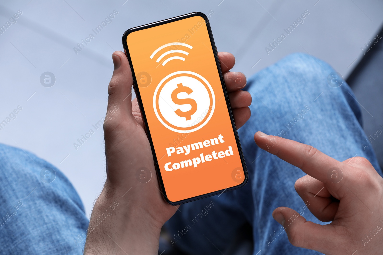 Image of Man successfully made payment using online banking application on smartphone indoors, closeup