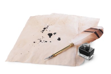 Photo of Parchment with stains of ink, feather pen and inkwell on white background
