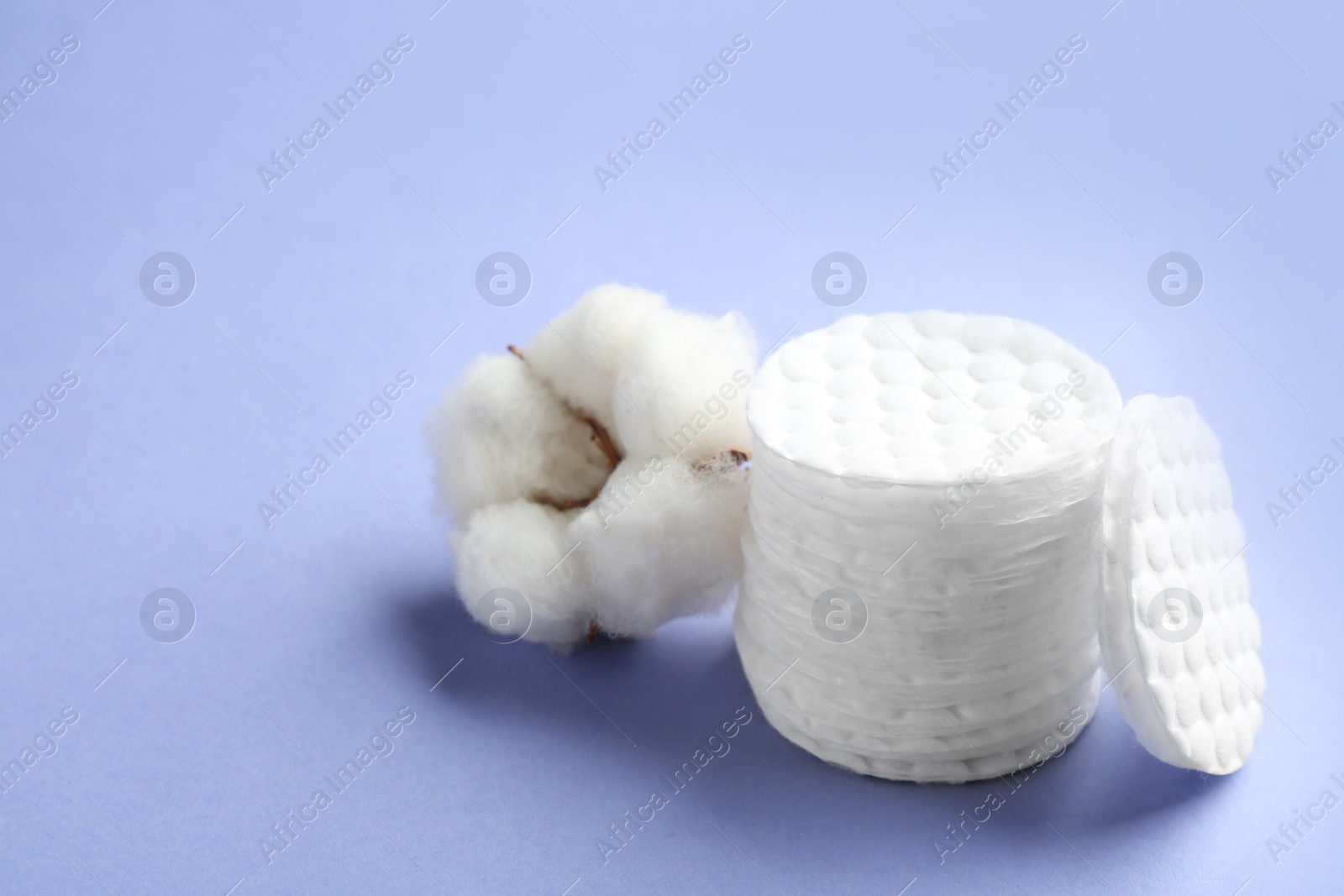 Photo of Composition with cotton pads and flower on color background. Space for text